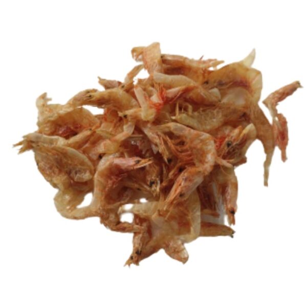 Close-up of dried prawns spread on a wooden surface, showcasing their vibrant orange color and crisp texture, used as a key ingredient in Asian cuisine